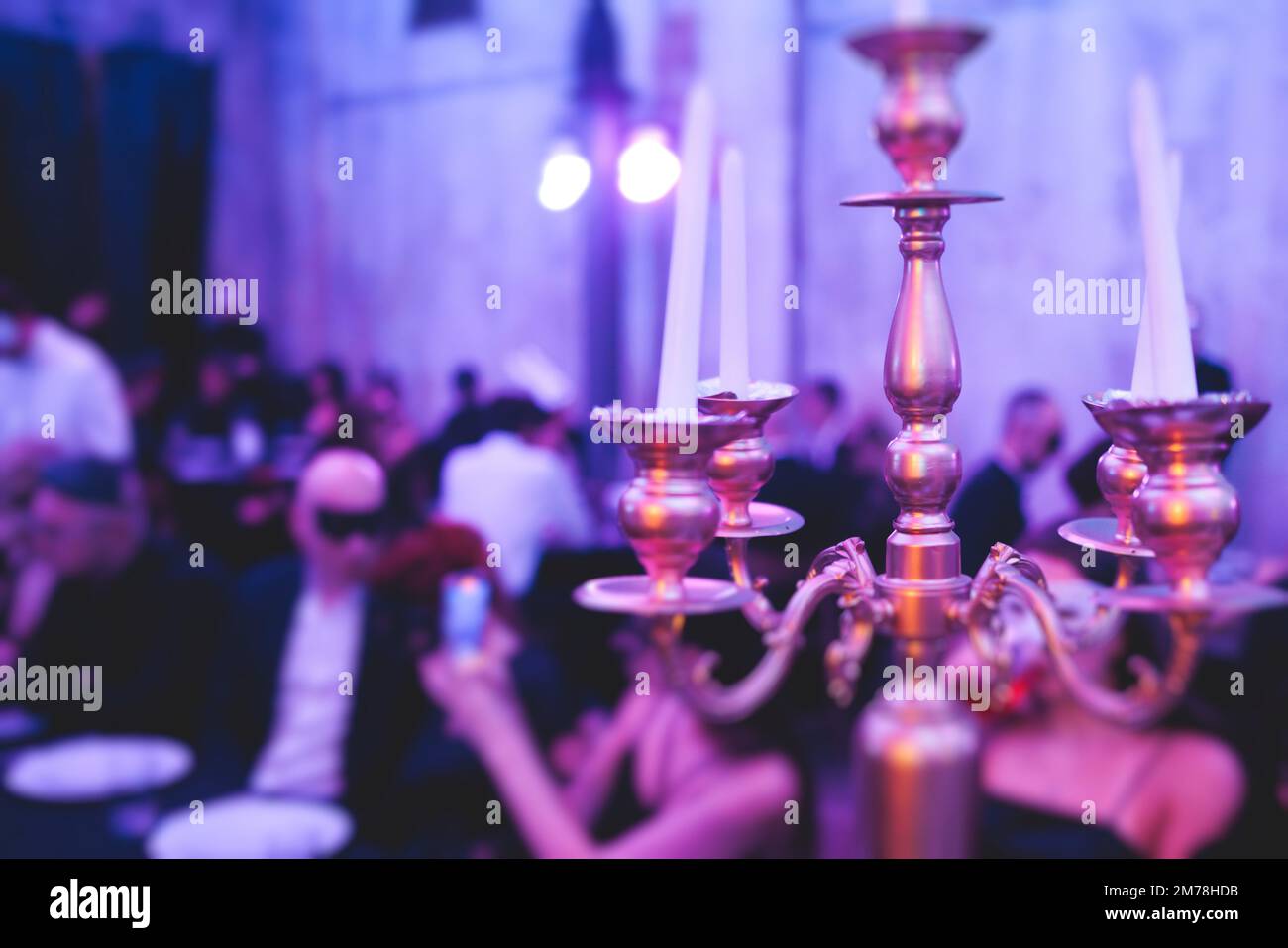 Vintage retro brass candlesticks with candles burning, luxury event