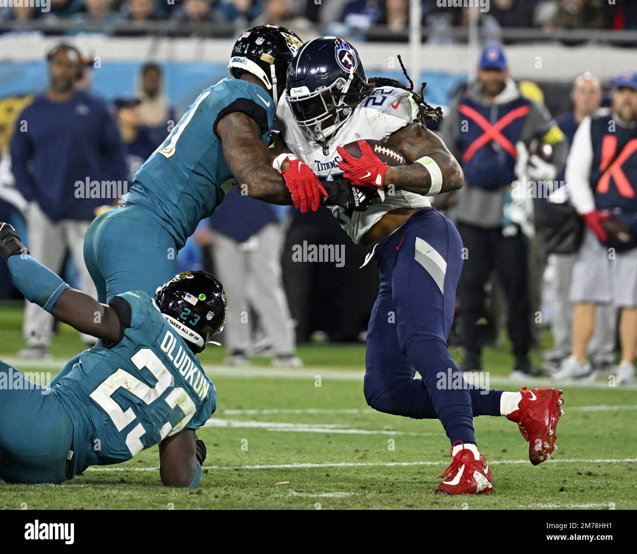 Jacksonville Jaguars linebacker Travon Walker (44) tackles Tennessee Titans  running back Derrick Henry in the second half of an NFL football game,  Saturday, Jan. 7, 2023, in Jacksonville, Fla. (AP Photo/John Raoux