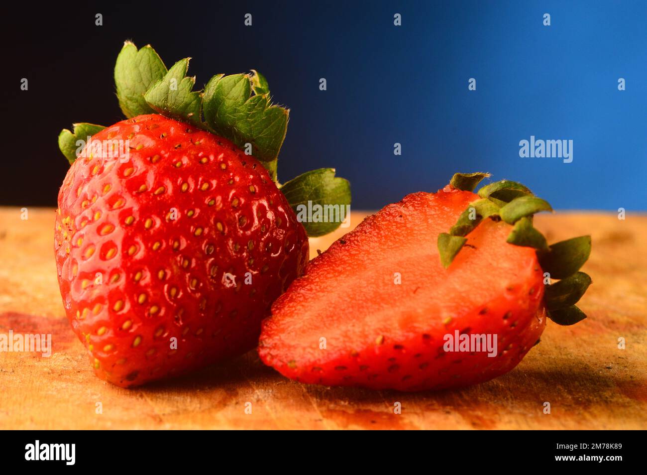Strawberry on studio shot, blue background Stock Photo - Alamy