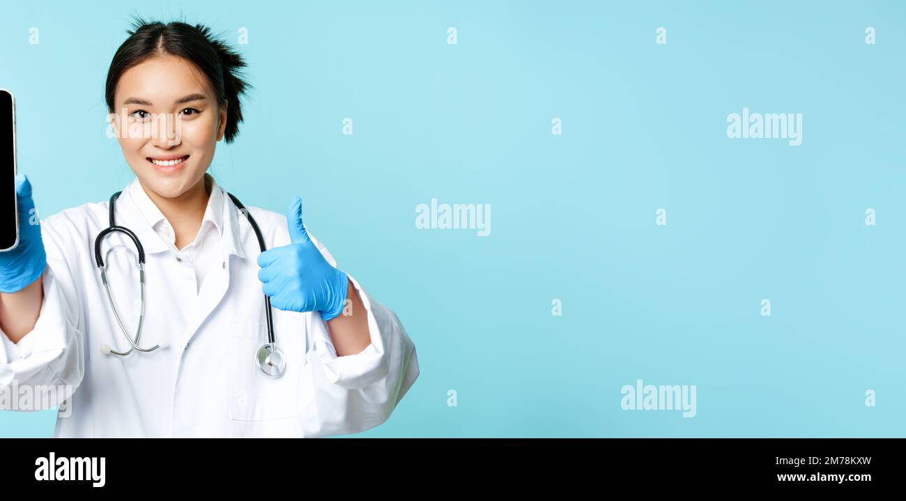 Web healthcare, online help concept. Smiling asian female doctor or ...
