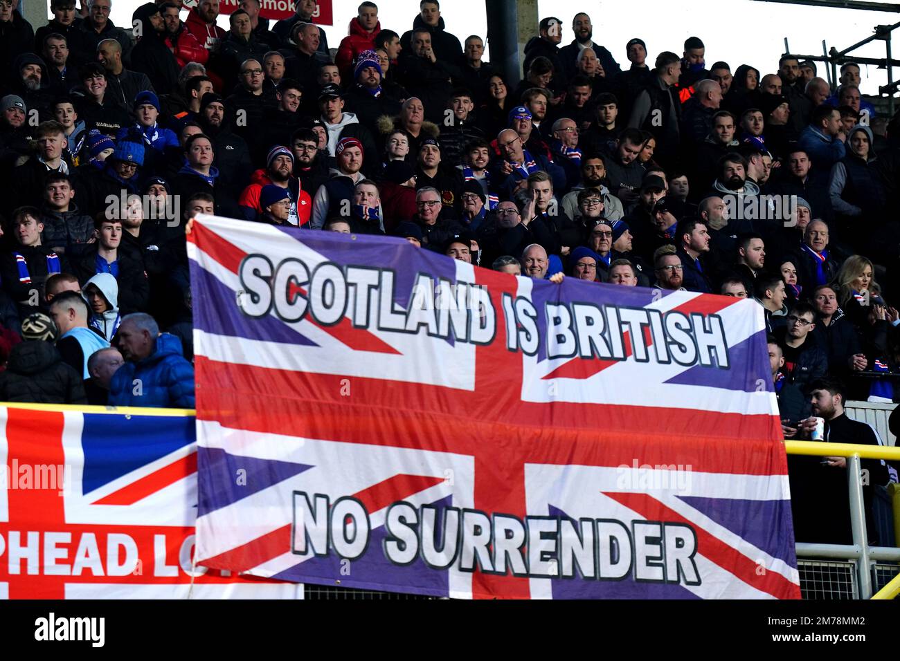 Rangers fans in the away stand hold up flags of the Union Jack saying