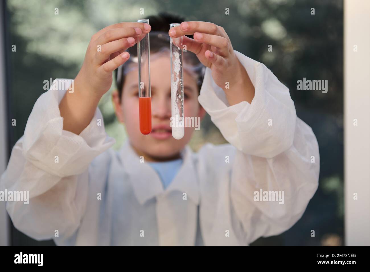 Test Tube Feature Details: test tubes with chemicals in hands of schoolboy chemist ...