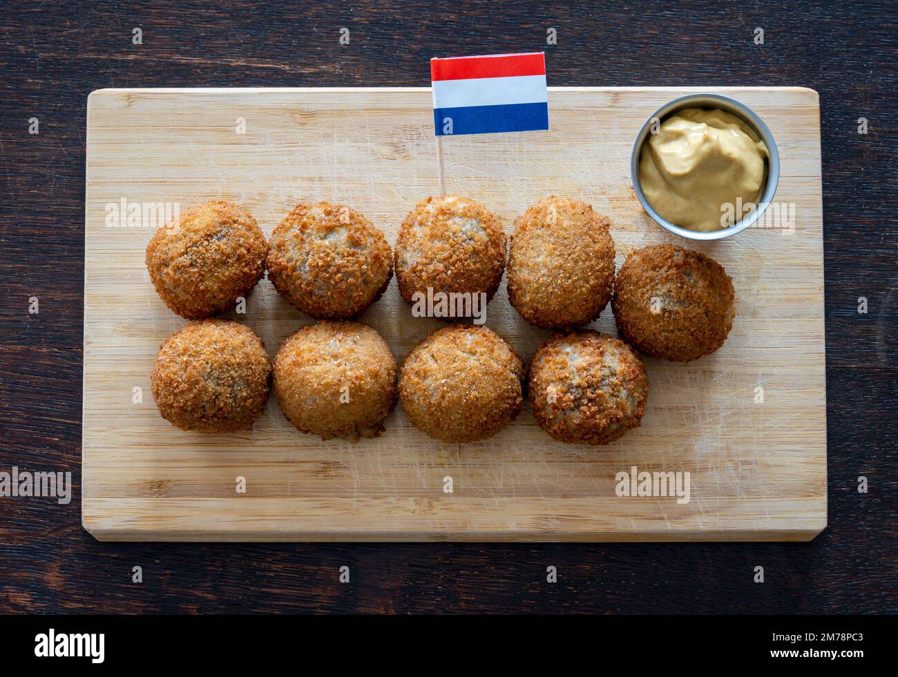 Bitterballen, a typical dutch snack similar to croquettes, served with mustard sauce Stock Photo