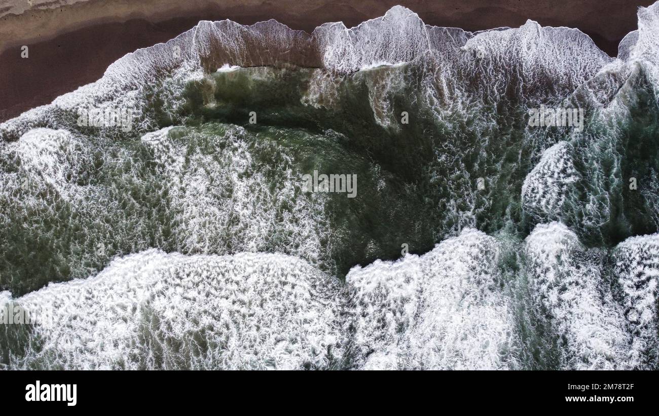 An aerial view of sea waves splashing on a seashore Stock Photo - Alamy
