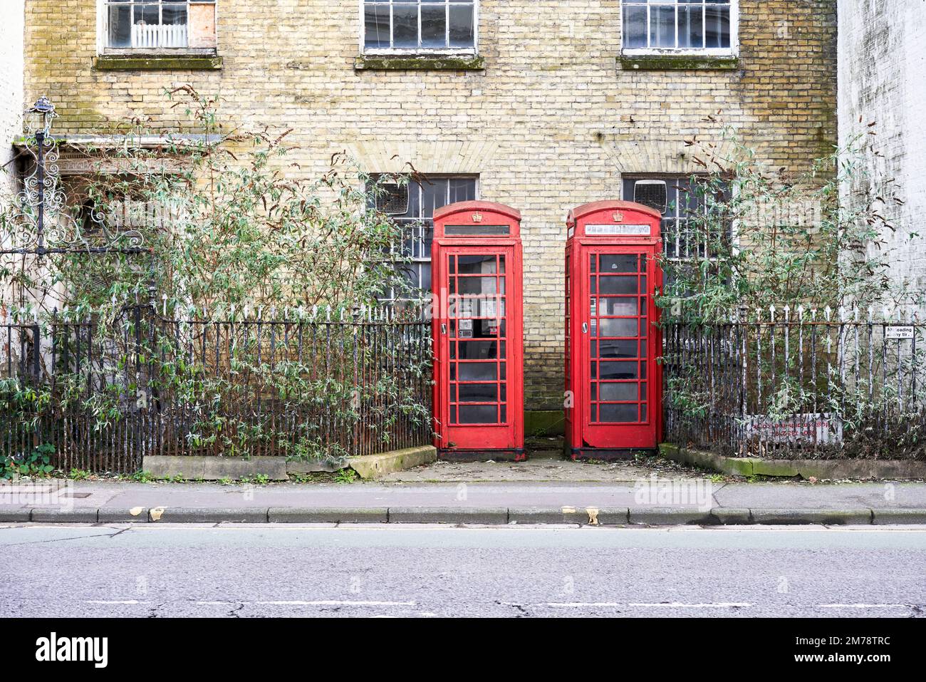 Old traditional British red telephone kiosks left to decay Stock Photo
