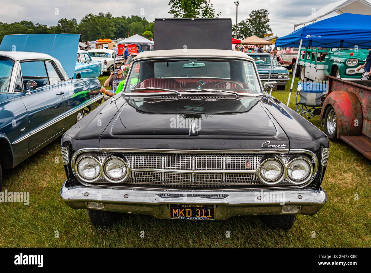 Iola, WI - July 07, 2022: High perspective front view of a 1964 Mercury Comet Caliente Convertible at a local car show. Stock Photo