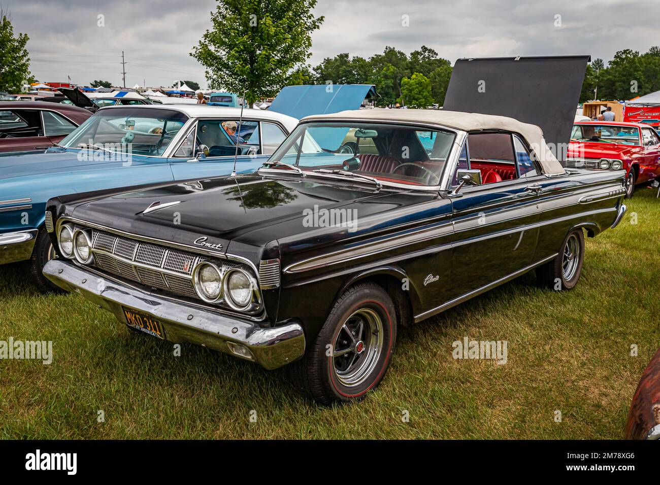 Iola, WI - July 07, 2022: High perspective front corner view of a 1964 Mercury Comet Caliente Convertible at a local car show. Stock Photo