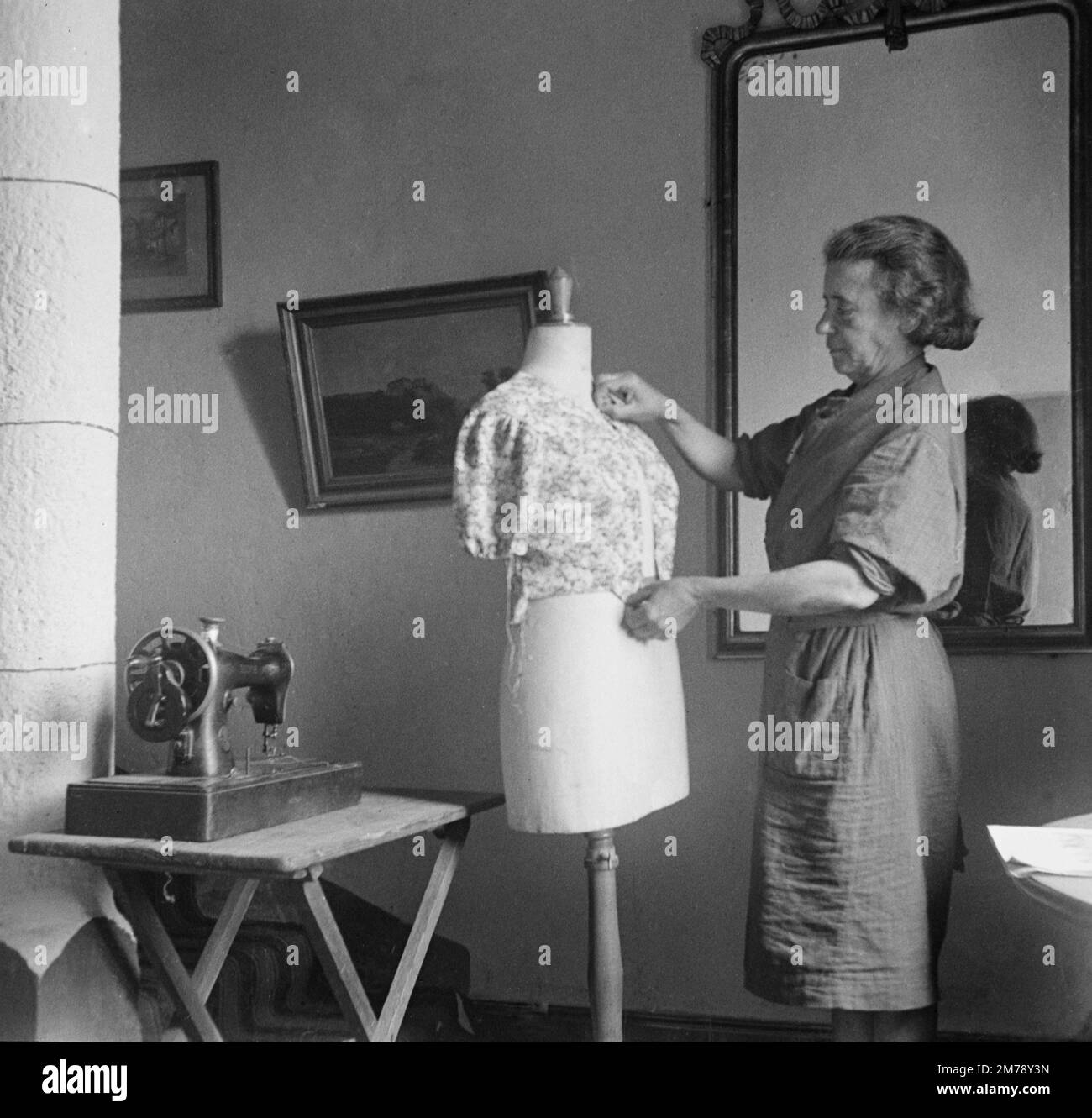 1940s Dressmaker, Tailoress or Seamstress and Mannequin or Dummy France 1943. Vintage black and white or monochrome photograph. Stock Photo