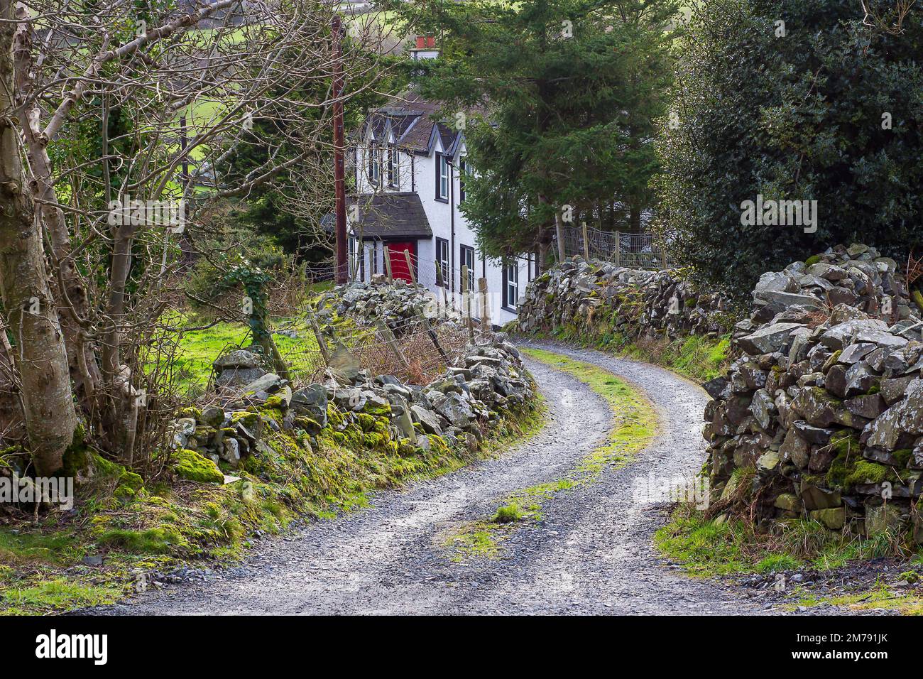 31 Jan 2018, A Large dwelling house located in a narrow country lane in  The Mountains of Mourne with high snow capped mountains in the background in Stock Photo