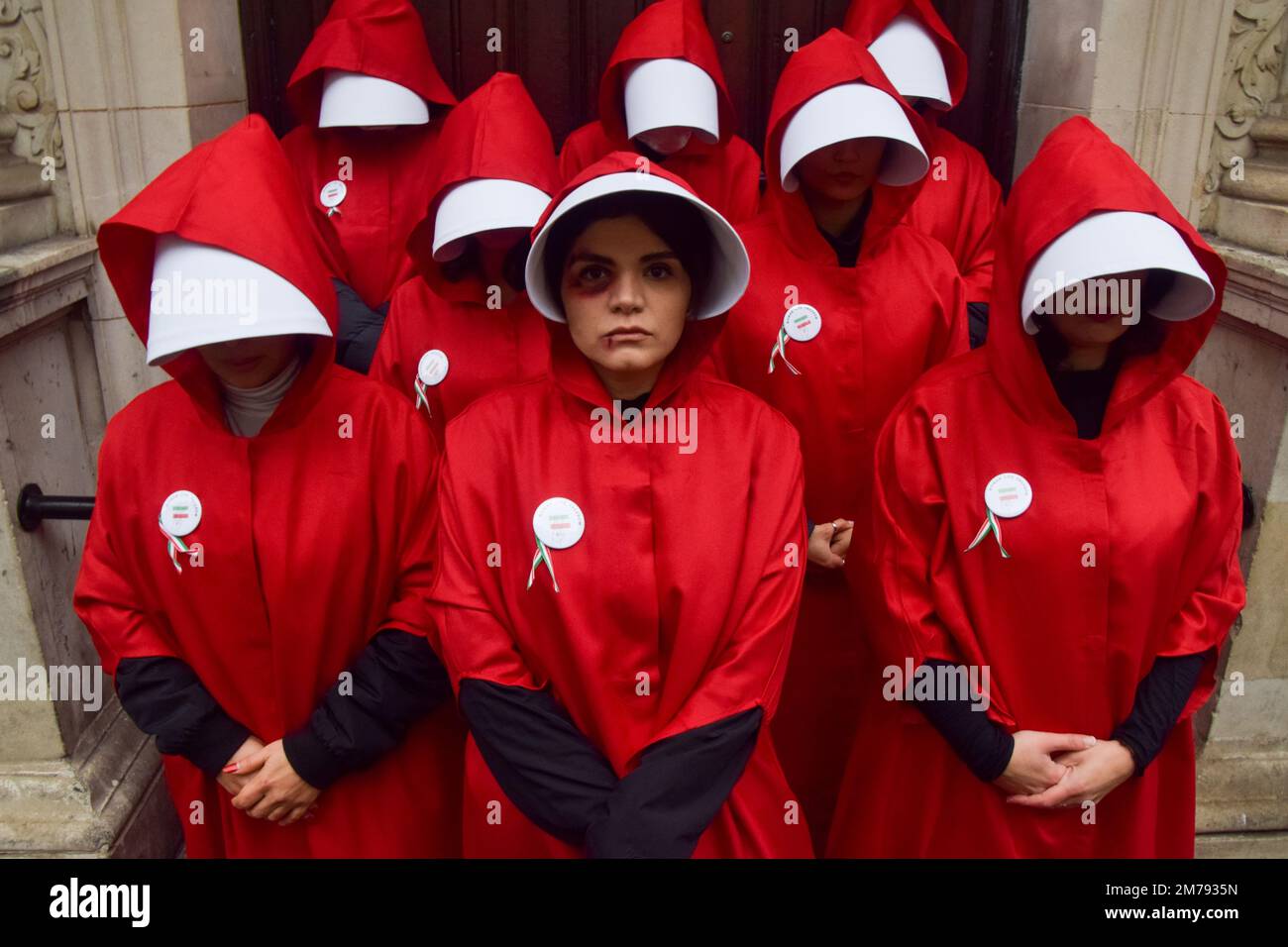London, UK. 7th January 2023. Protesters in Covent Garden. Women wearing The Handmaid's Tale costumes marched through Central London in protest against the executions in Iran, in support of freedom, and in solidarity with women in Iran. Stock Photo