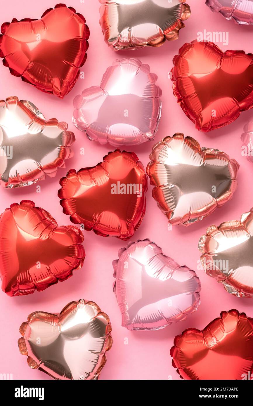 Pink background with red hearts balloons Stock Photo - Alamy