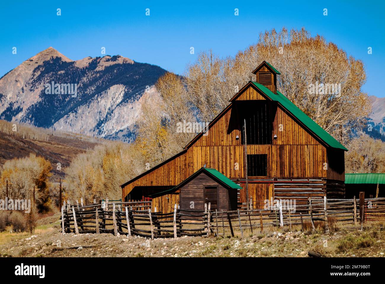 Beautiful wooden ranch barn; Mt. Crested Butte beyond; Colorado; USA Stock Photo