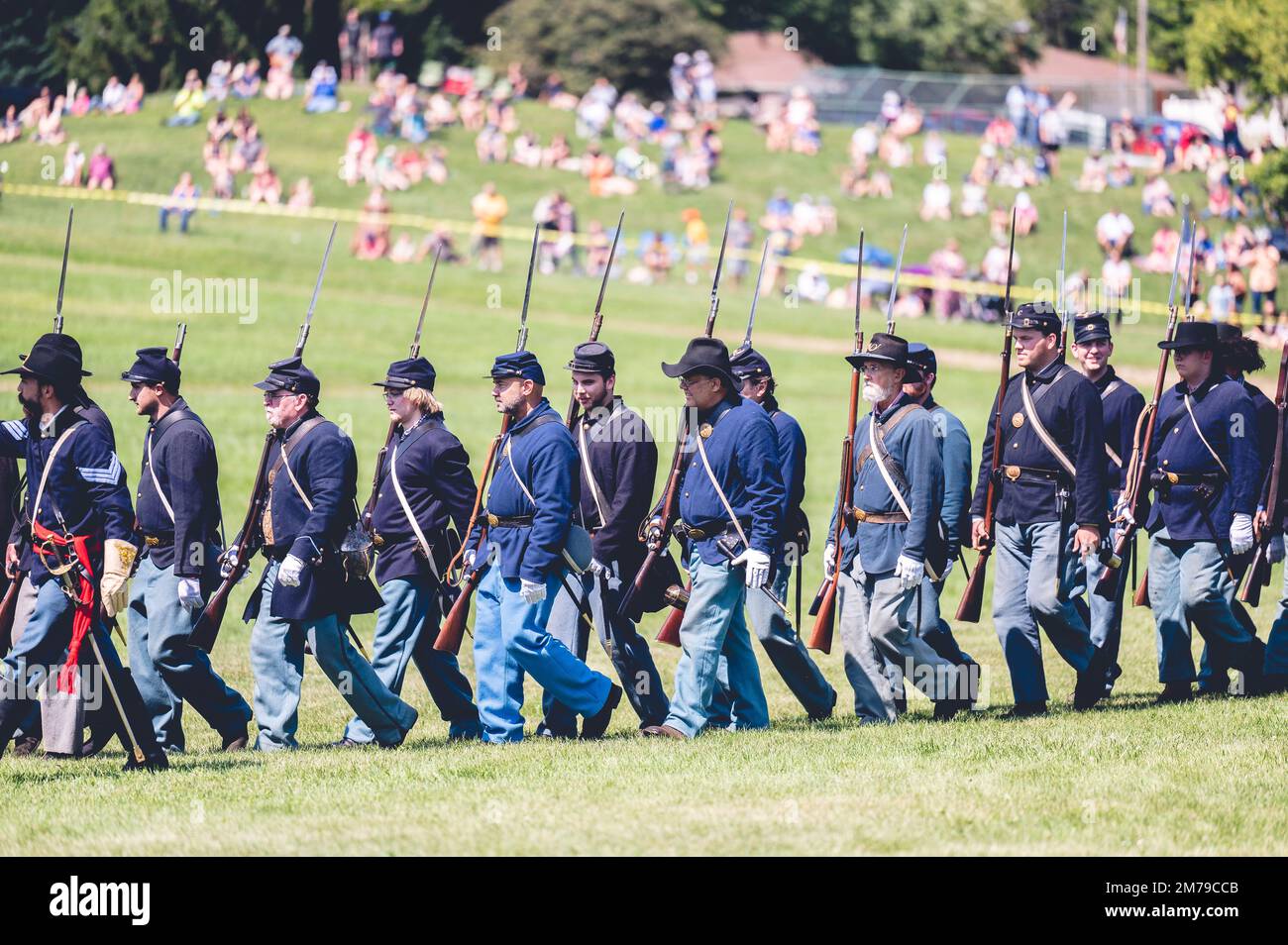 A shallow focus view of soldiers marching at a Civil war reenactment in
