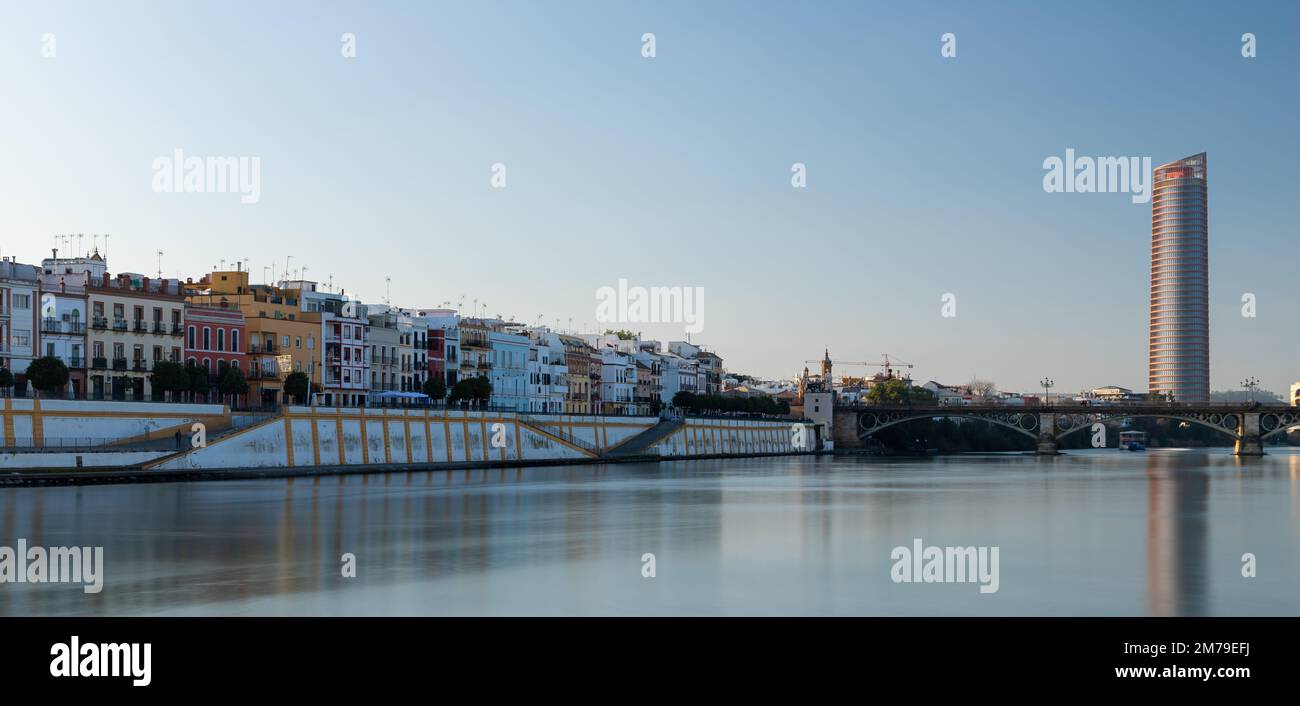 Sunset over the authentic neighborhood of Tirana in Seville with views on Calle Betis, Torre Sevilla and with awesome reflections in the Guadalquivir Stock Photo