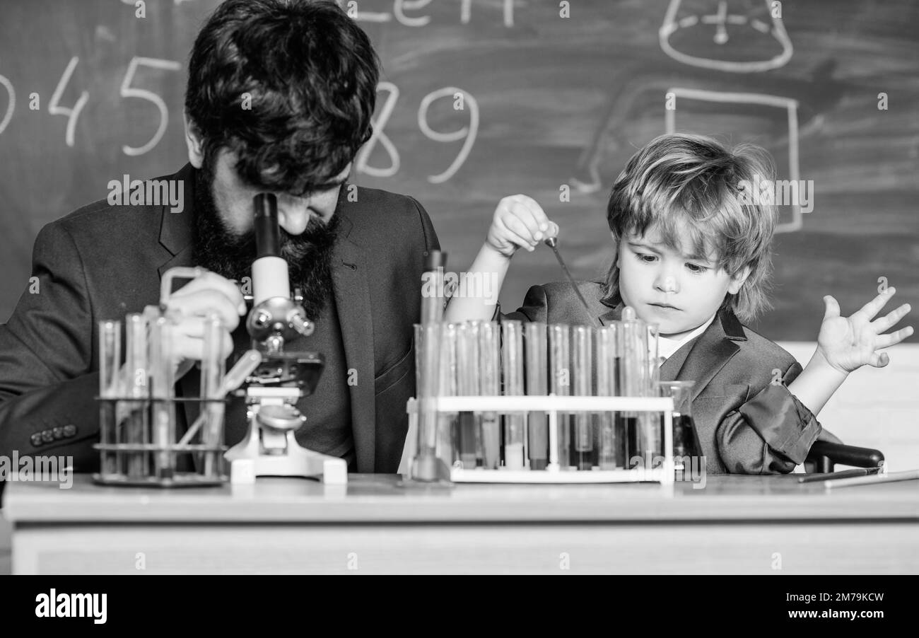 microscope. bearded man teacher with little boy. laboratory research and development. Chemistry