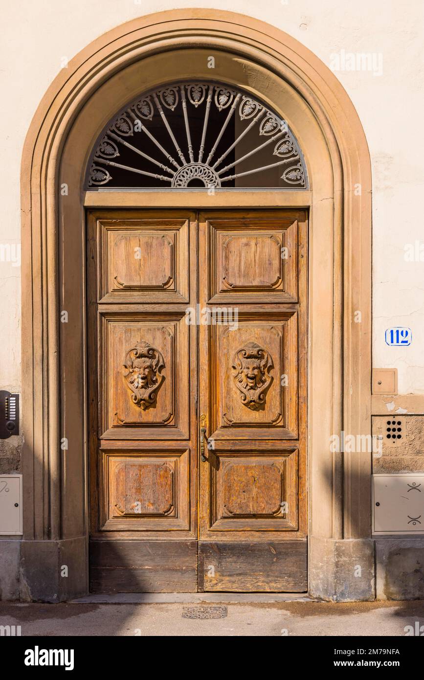 Ornate round arch front door, Florence, Tuscany, Italy Stock Photo