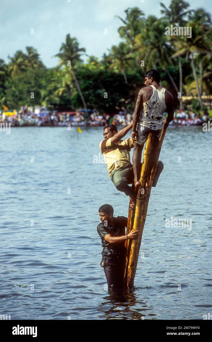 Enthusiastic spectators on a post in Nehru Trophy Boat Race, Alappuzha Alleppey, Kerala, South India, India, Asia Stock Photo