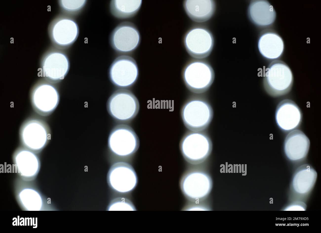 Background, bokeh blurred light from garlands burning with white light Stock Photo