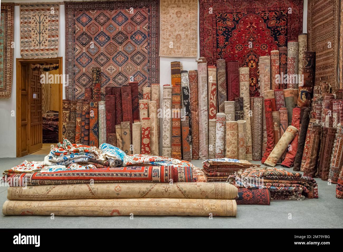 Variety of the oriental carpets in traditional carpet store in