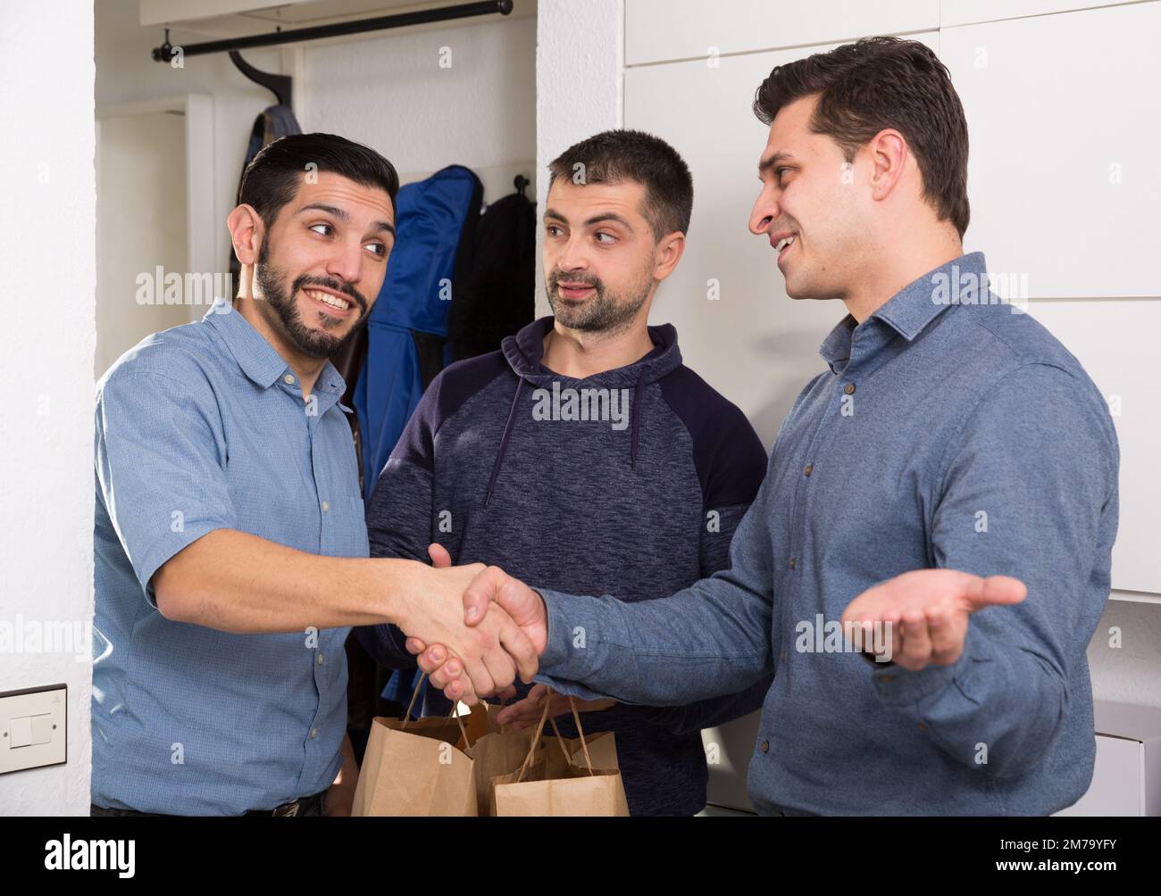 Three men getting for bachelor gatherings at home Stock Photo - Alamy