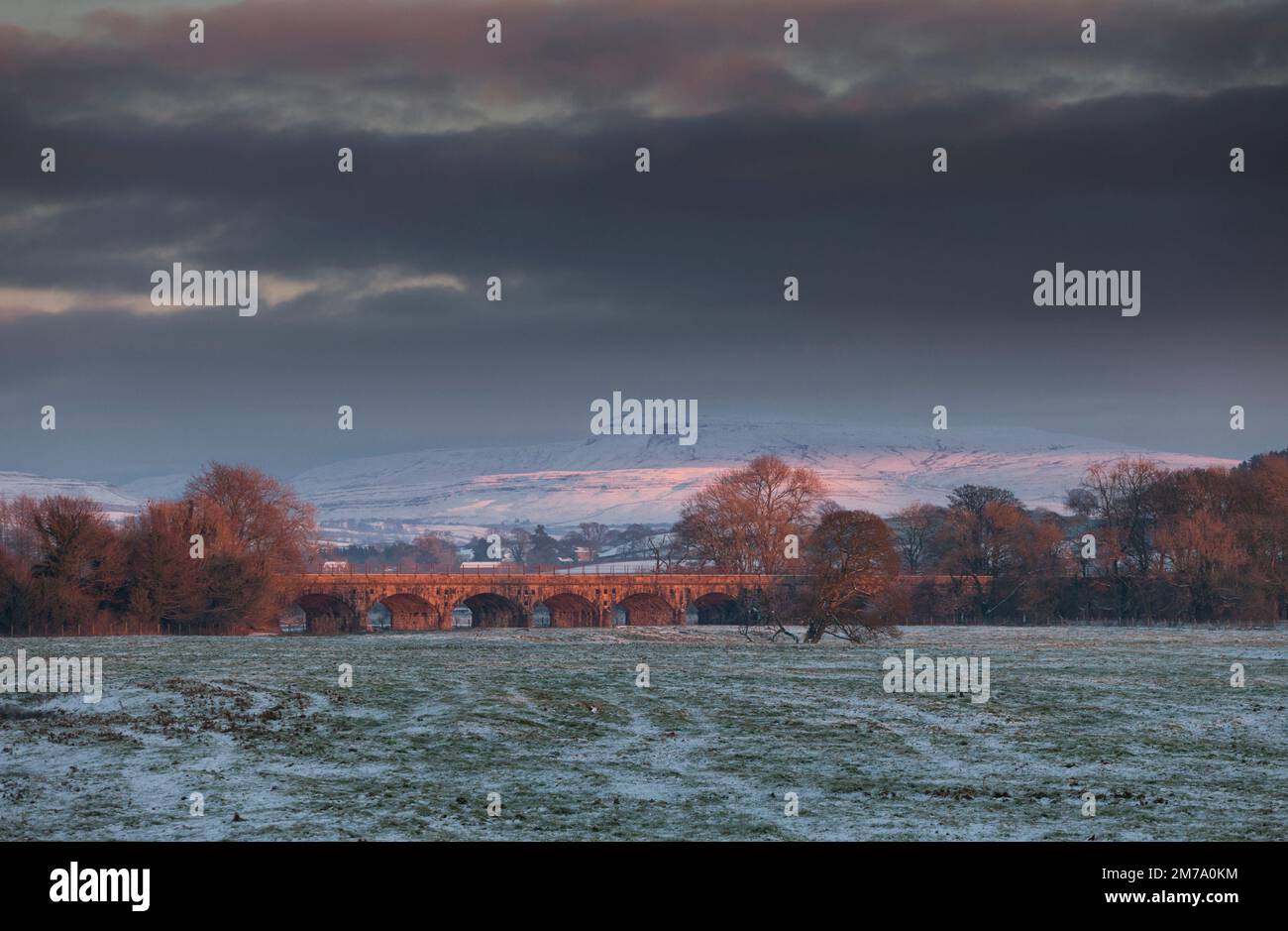 Melling railway viaduct on the little north western line with a snow capped Ingleborough behind Stock Photo