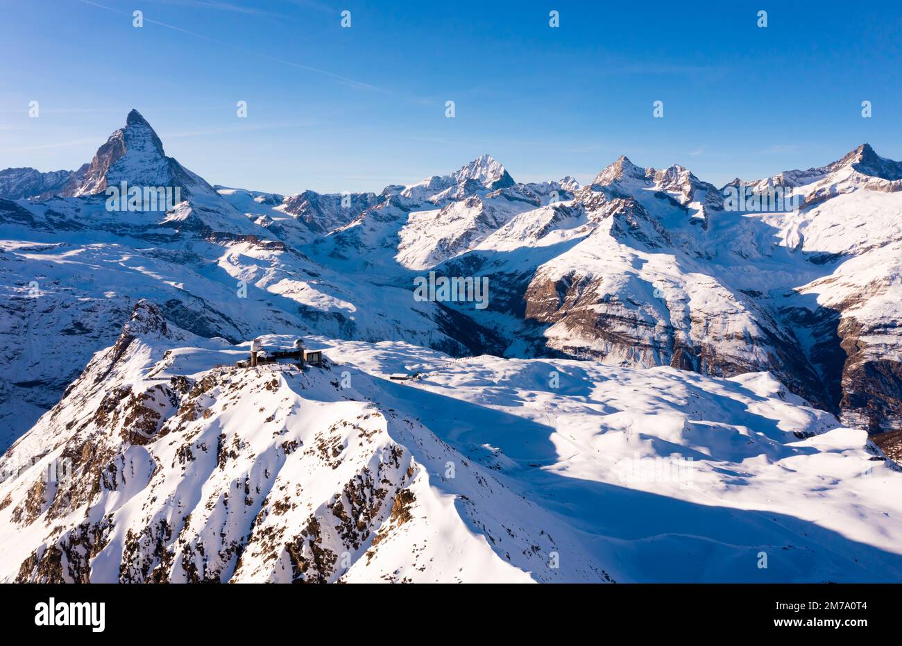 Mountain ridge Gornergrat with observatory on background of Matterhorn peak, Switzerland Stock Photo