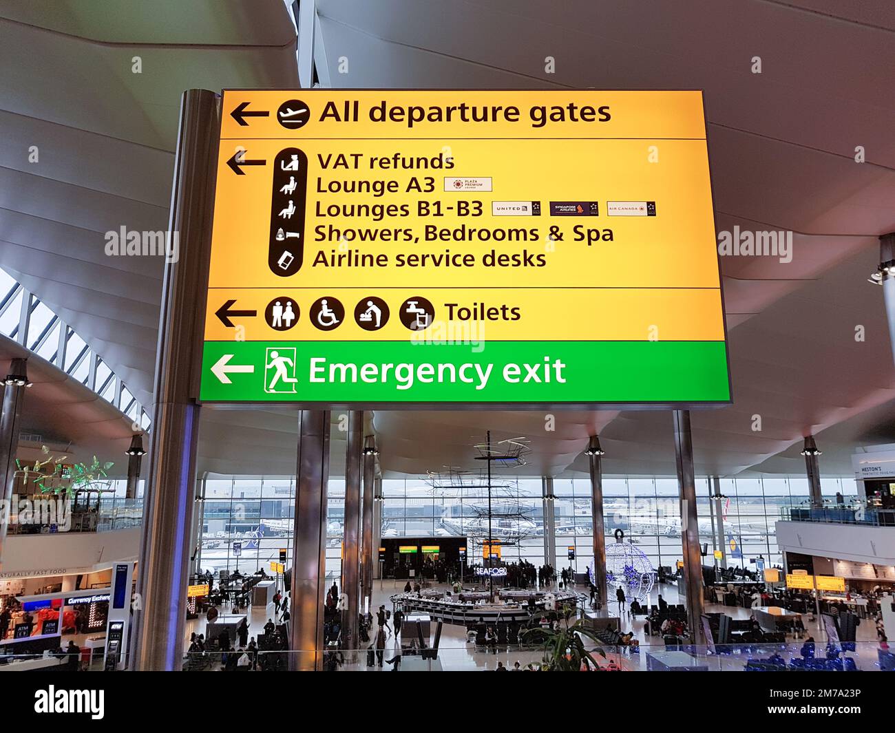 London, UK - December 2017 : Heathrow Airport Information signboard pointing to direction of departure gates, lounges, toilets, etc Stock Photo