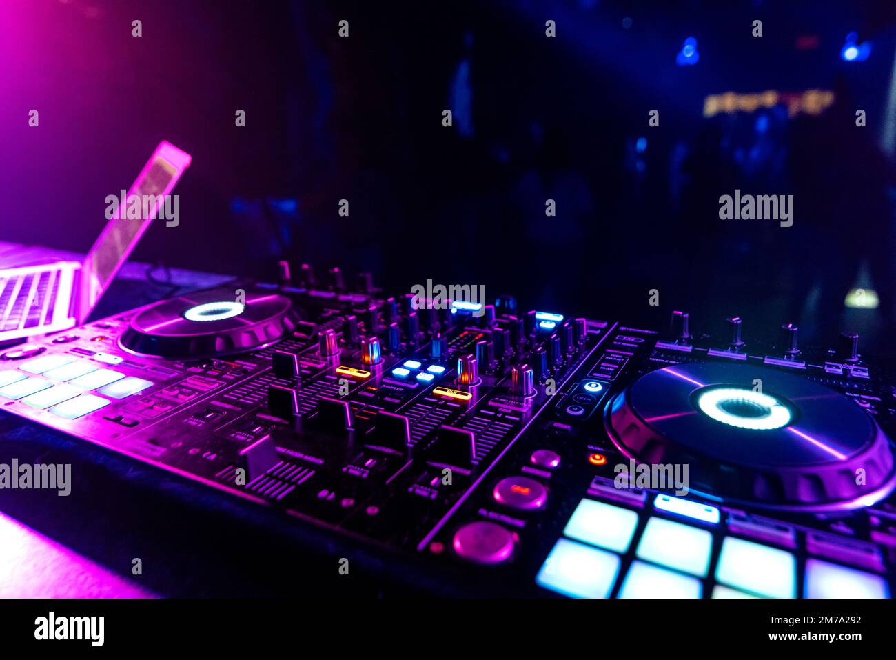 DJ mixer in the booth on the background of the dance floor