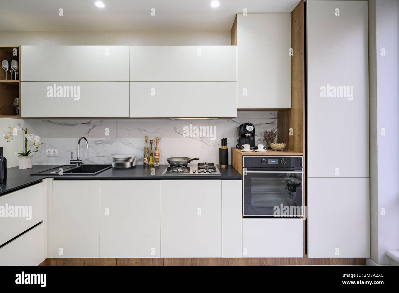 Large black and white luxury kitchen interior, front view Stock Photo