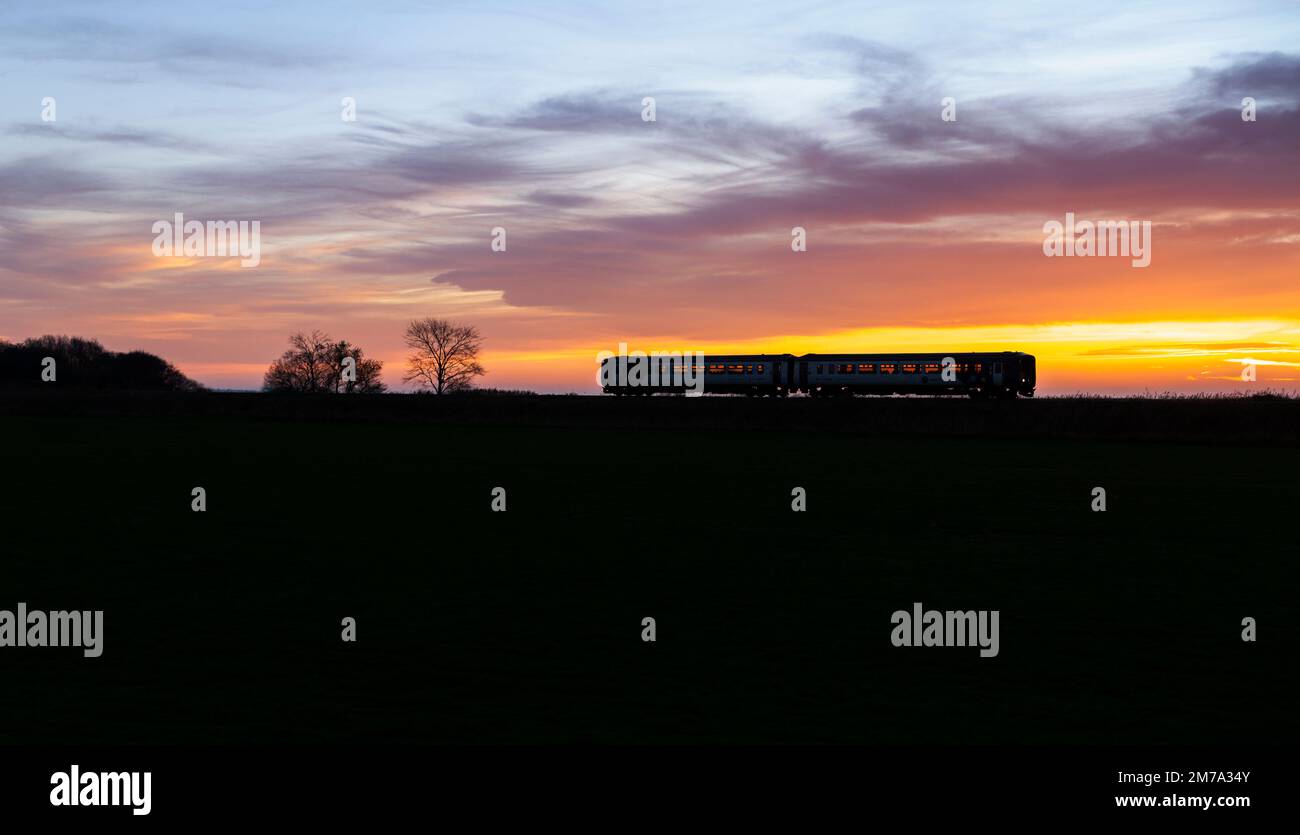Northern rail class 156 DMU train passing Silverdale on the Cumbrian coast railway making a