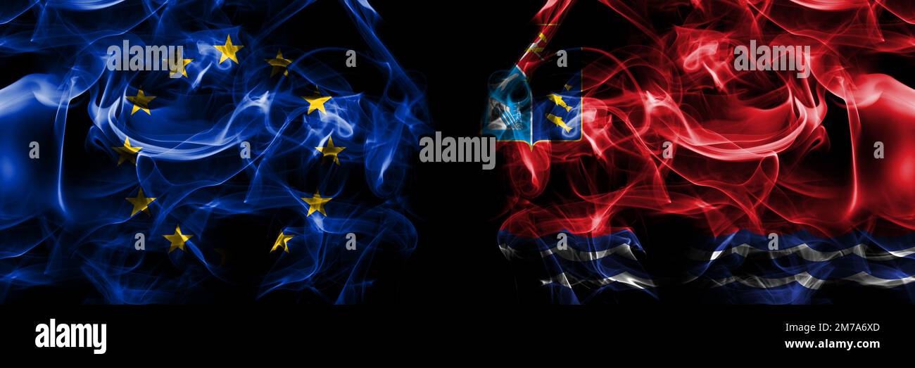 Flags of EU, European Union vs Russia, Russian, Magadan Oblast. Smoke flag placed side by side on black background. Stock Photo