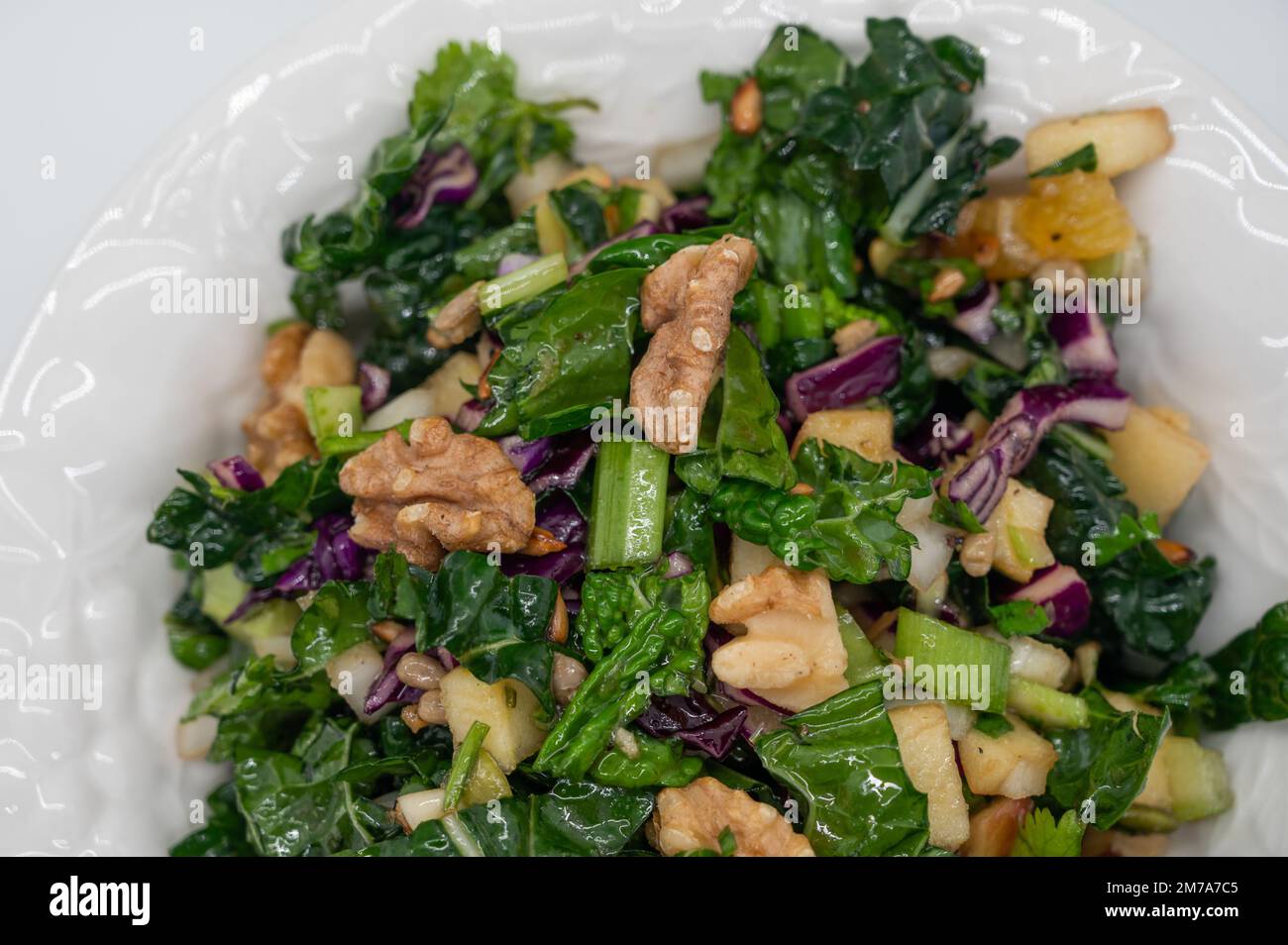 Healthy raw lacinato kale salad with walnuts and pear Stock Photo Alamy