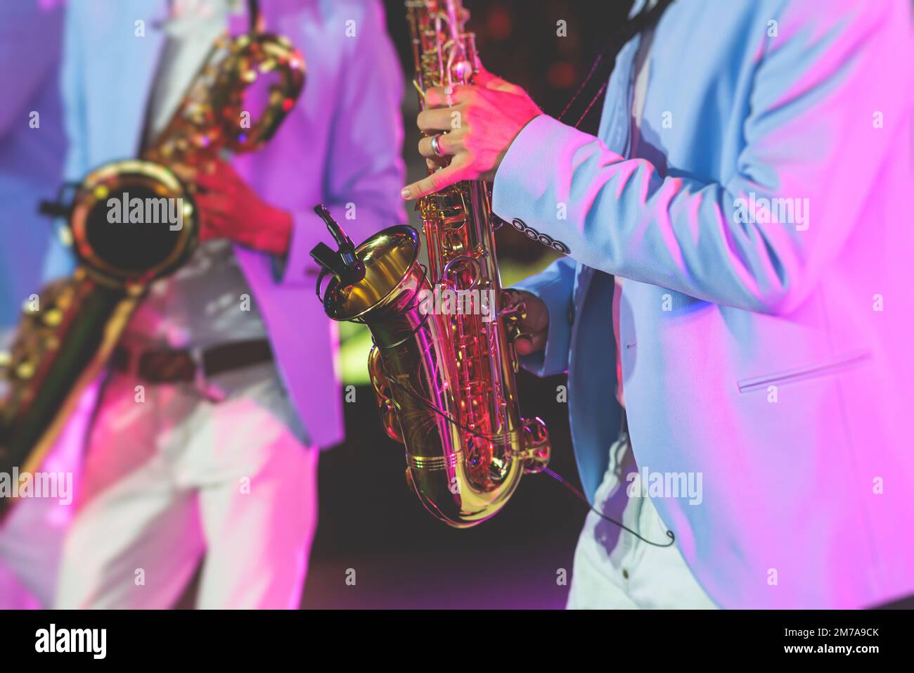 Concert view of saxophonist, a saxophone sax player with vocalist and musical band during jazz