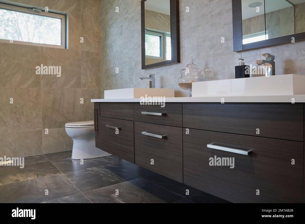 White rectangular porcelain sinks and charcoal wooden vanity in ...
