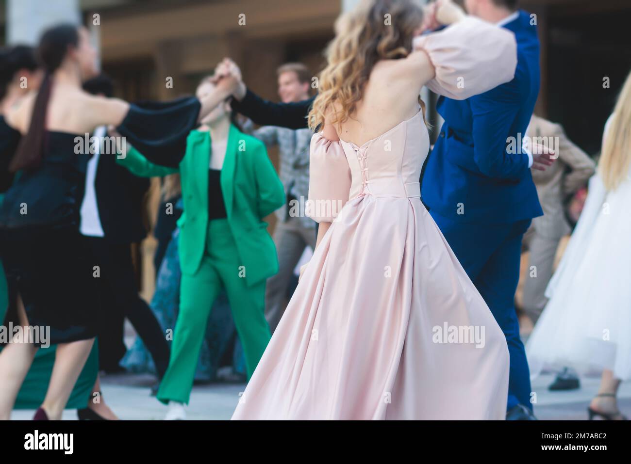 High school graduates dancing waltz and classical ball dance in dresses
