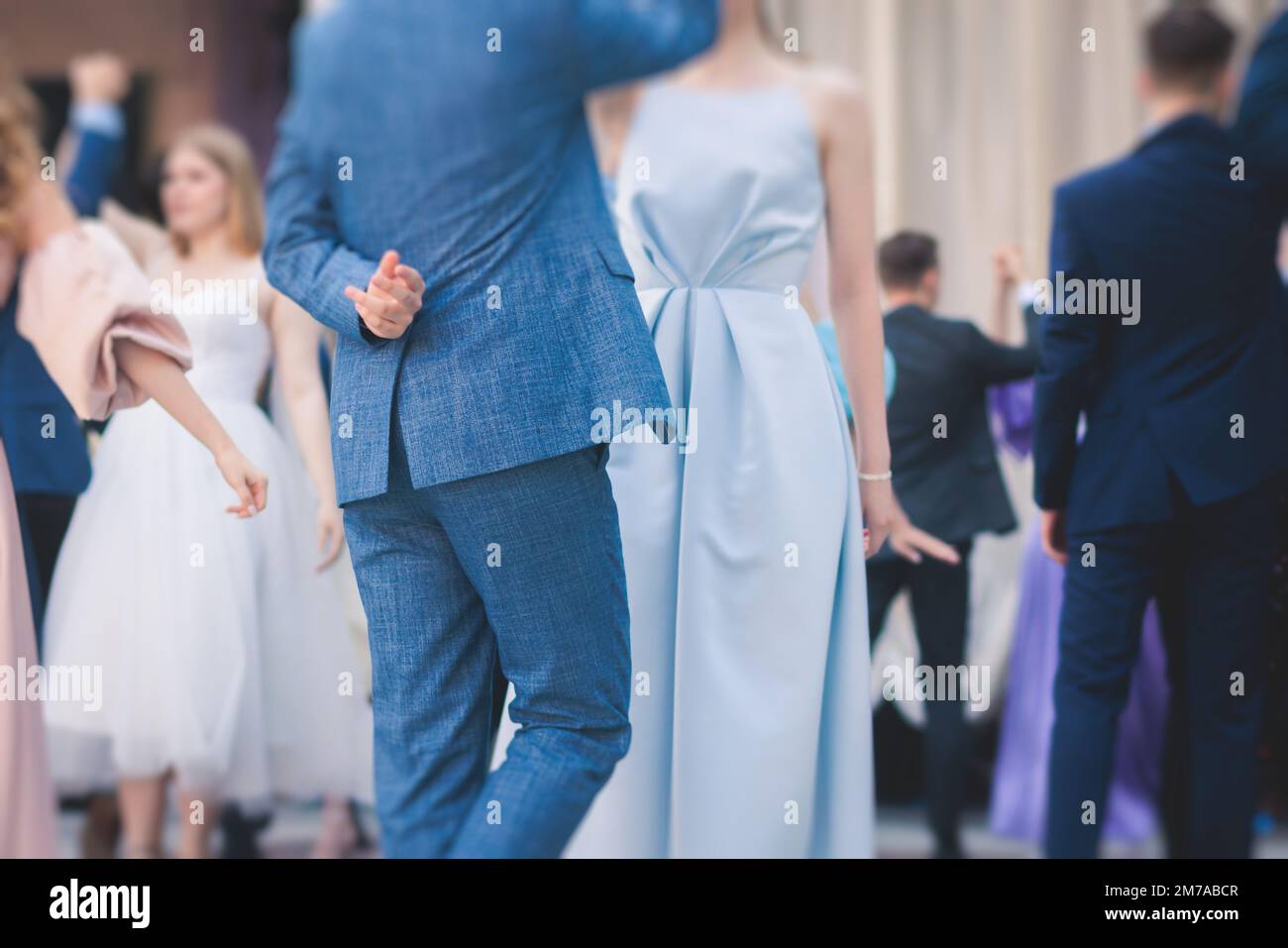 High school graduates dancing waltz and classical ball dance in dresses