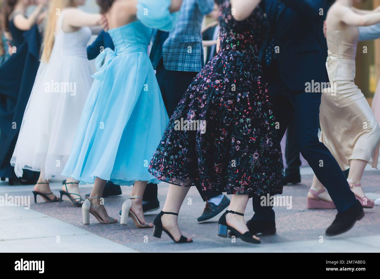 High school graduates dancing waltz and classical ball dance in dresses