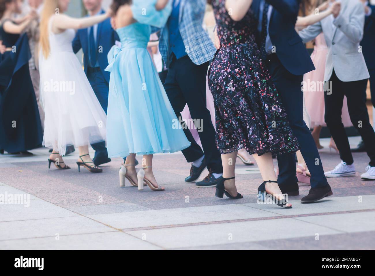 High school graduates dancing waltz and classical ball dance in dresses