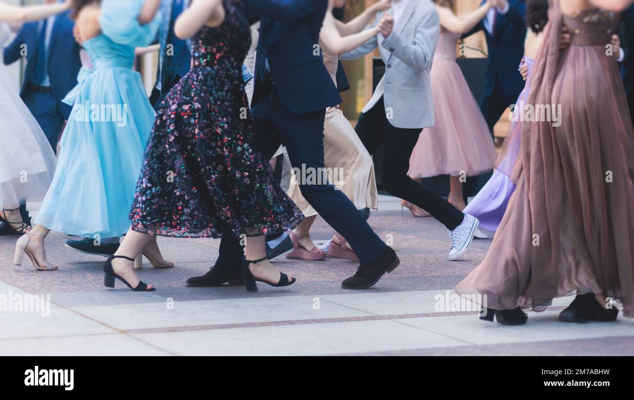 High school graduates dancing waltz and classical ball dance in dresses