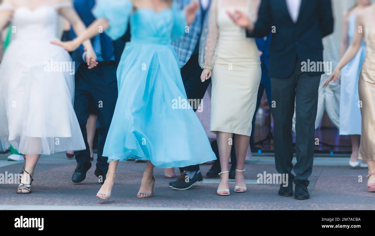 High school graduates dancing waltz and classical ball dance in dresses