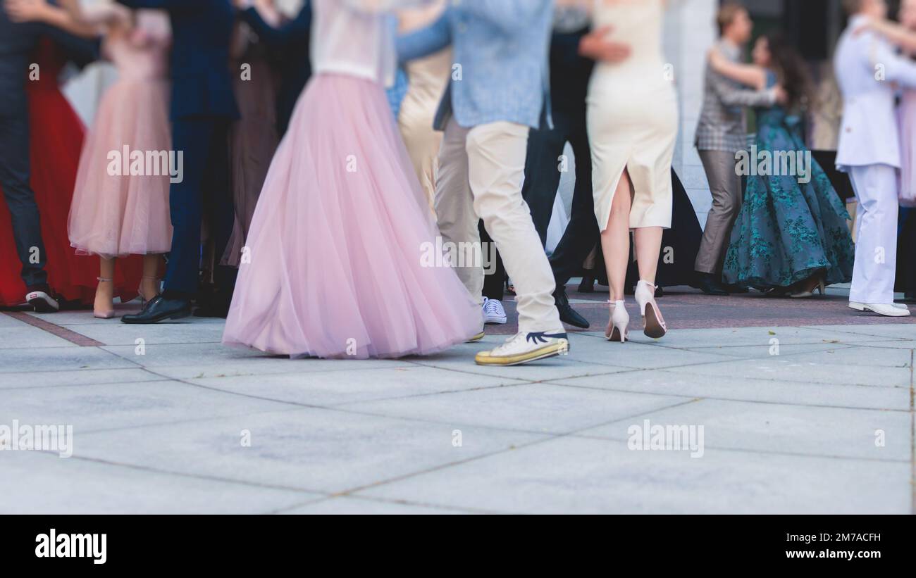 High school graduates dancing waltz and classical ball dance in dresses