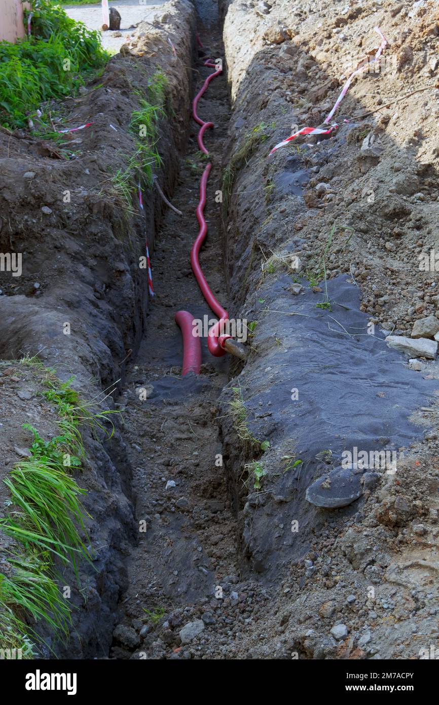 Laying electrical cables in a trench at a construction site closeup