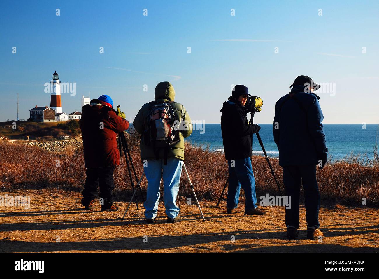 Bird watchers count the birds through their telescopes while braving a brisk cold day in Montauk, Long Island, New York Stock Photo