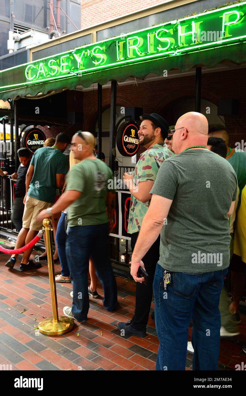 Men wearing their green best, ready to celebrate St Patrick's Day line up at an Irish style pub in Los Angeles Stock Photo