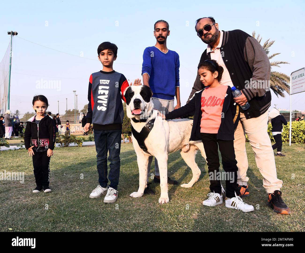 Karachi. 8th Jan, 2023. People pose for a photo with a dog during a dog