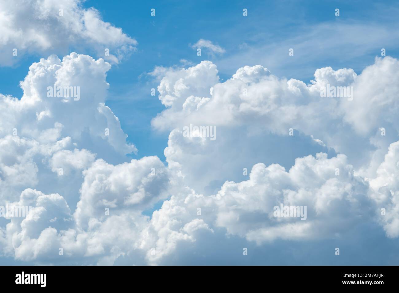 White fluffy clouds on blue sky. Soft touch feeling like cotton. White puffy cloudscape. Beauty in nature. Close-up white cumulus clouds texture Stock Photo