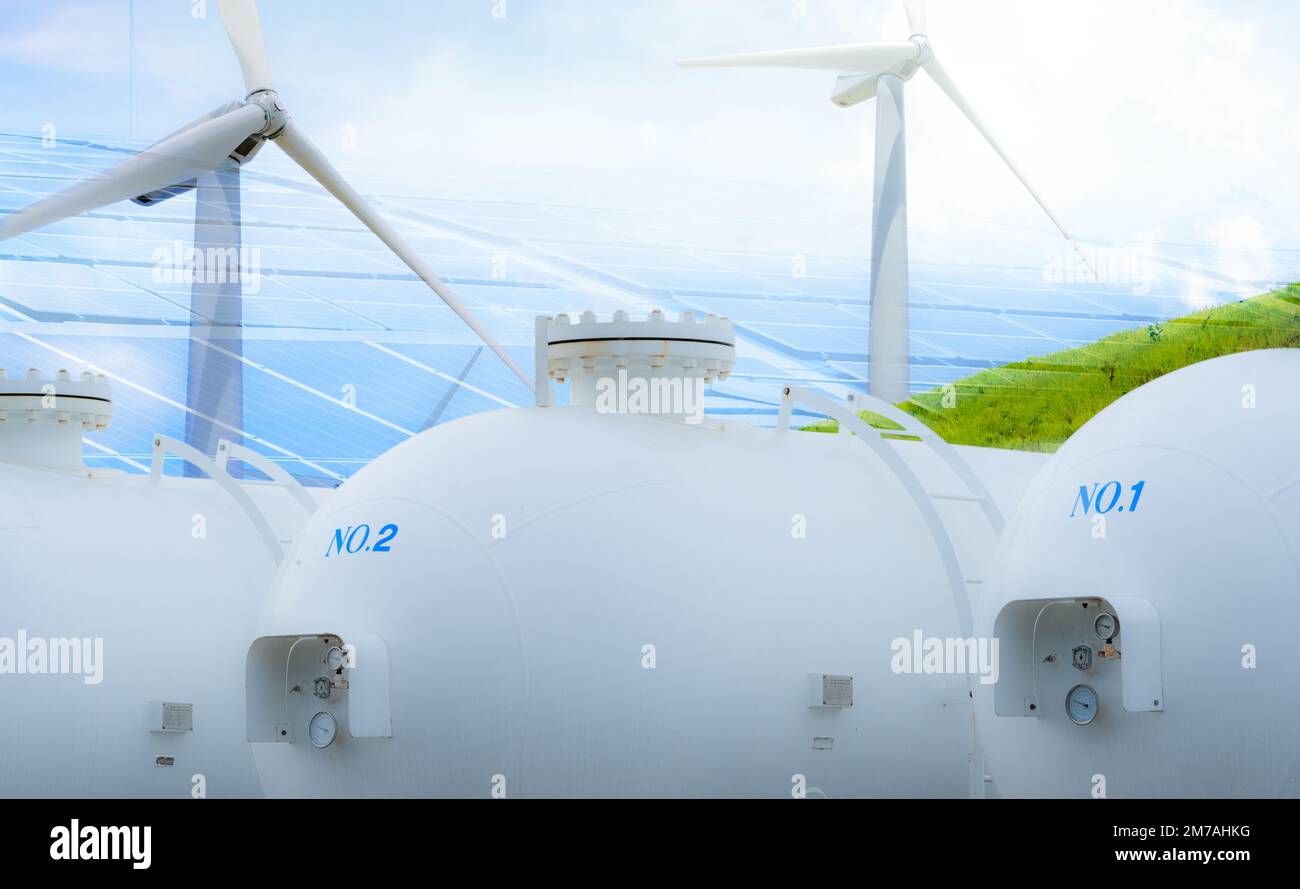 H2 fuel storage tank with green hydrogen concept. Sustainable renewable energy. Net zero emissions by 2050. Solar panel and wind turbine generate Stock Photo