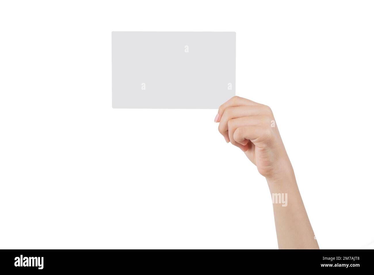 Hand of a young woman holding a white cardboard to mount an image or advertising text, with a white background. Stock Photo