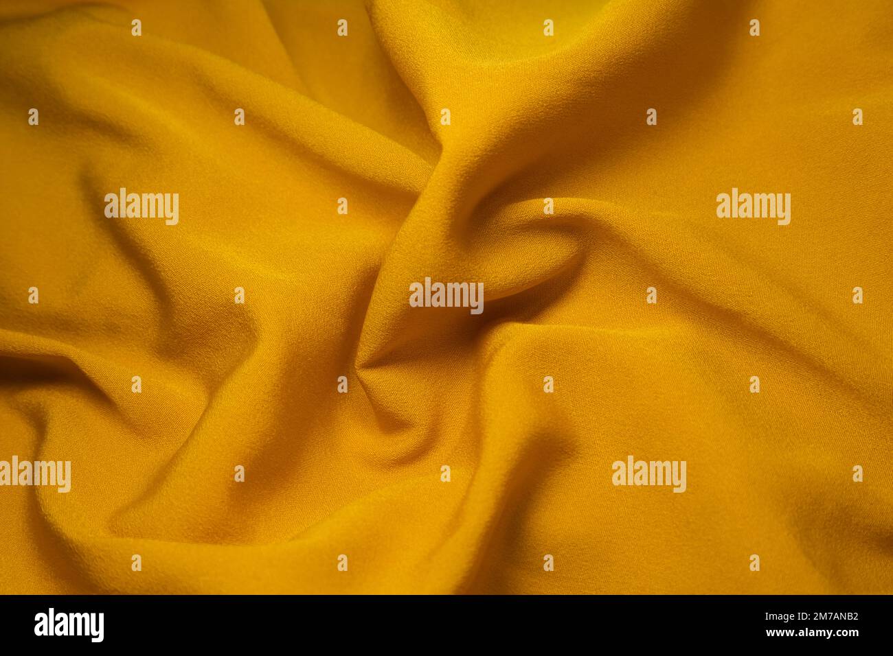 Yellow fabric background. Yellow cloth waves background texture. Yellow