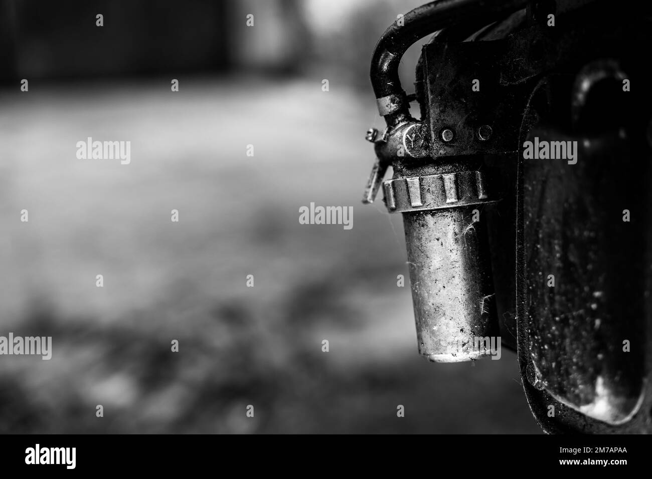 Diesel fuel filter on the body of a walkbehind tractor closeup, black and white photo Stock
